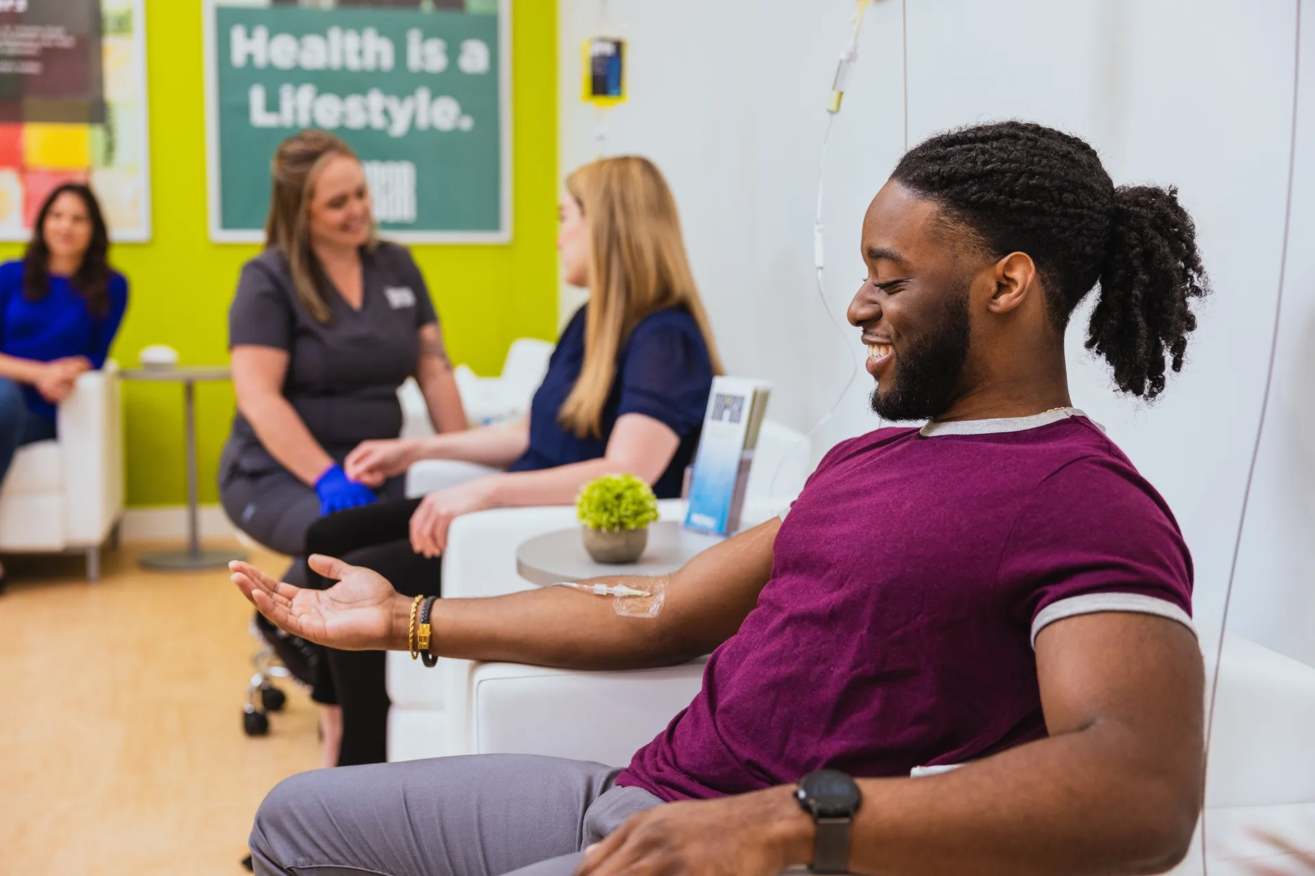 A nurse placing an IV for a smiling client