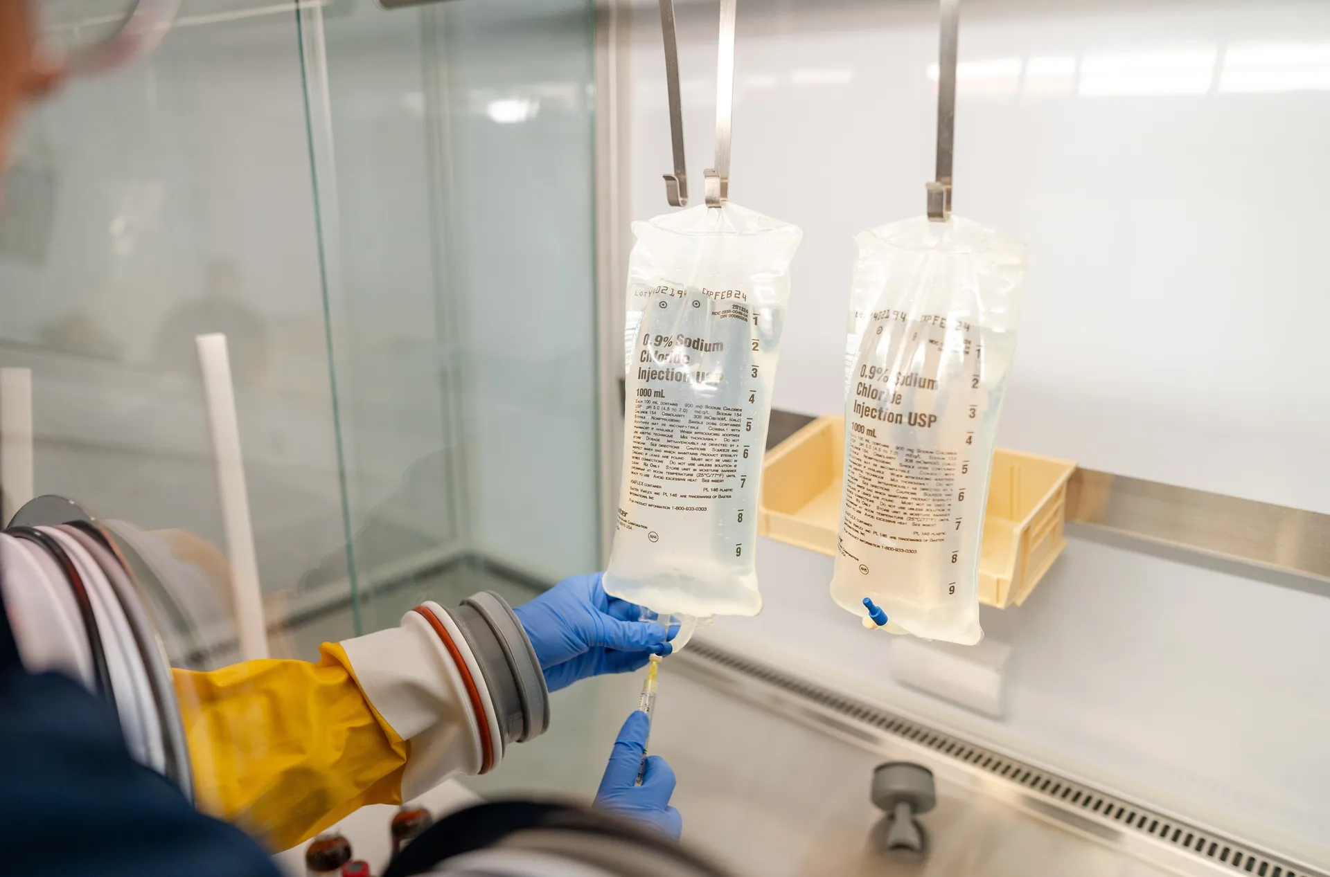 Saline bags inside the ISO Class 5 isolator hood